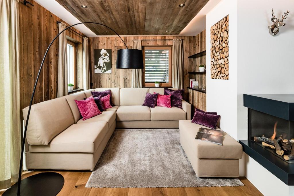 a living room with a couch and a fireplace at Paruda in Ortisei