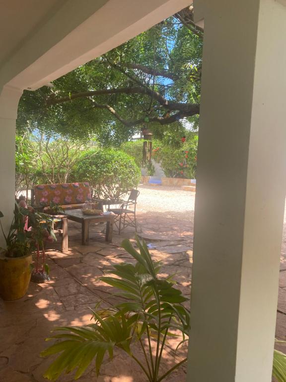 a patio with a bench and a table at FURAHA VILLA 3 in Chanjani