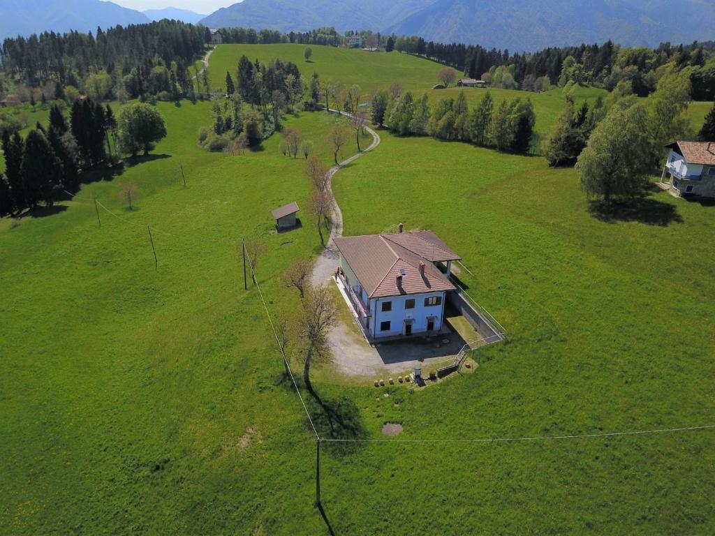 an aerial view of a house in a green field at Villa Glory Mountain Lake Iseo Hospitality in Bossico