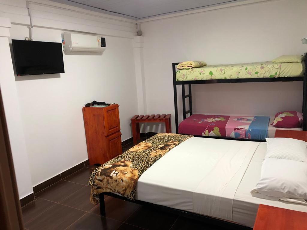 a bedroom with a bunk bed and a tv at Iguazu apart hostel in Puerto Iguazú