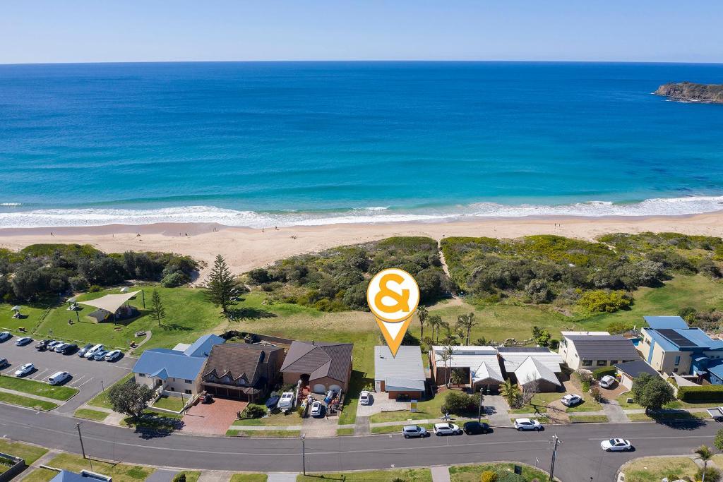 an overhead view of a house with a sign and the beach at Paradise on Jones Beach Kiama - Beachfront unit with direct beach access & views in Kiama Downs
