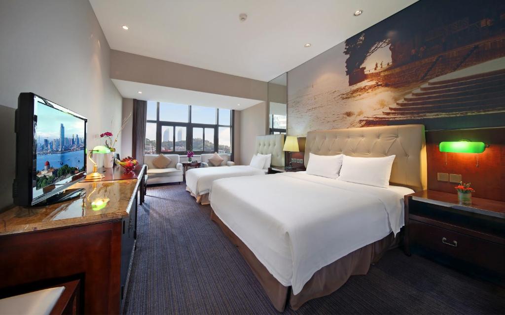 Postel nebo postele na pokoji v ubytování City Hotel Xiamen-Free Welcome Fruits