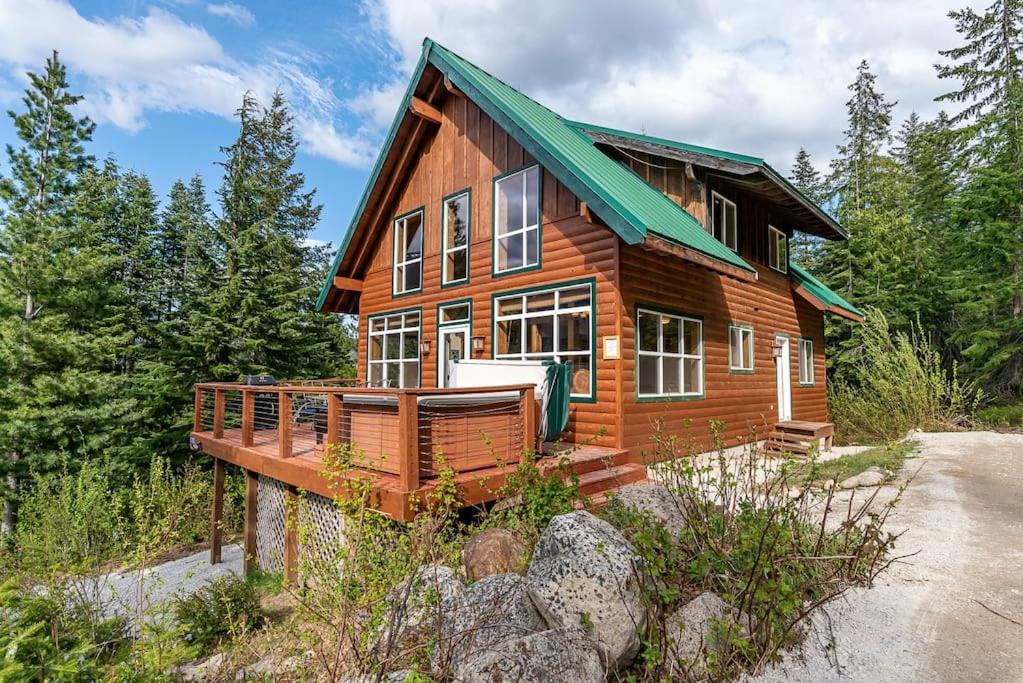 a wooden house with a green roof at Hot Tub Cool Views: Roaring Creek Cabin in Leavenworth