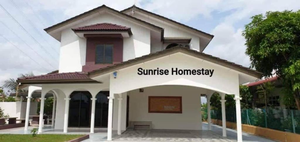 a church with a sign that reads sunrise homesteadbey at Sunrise Homestay in Alor Setar