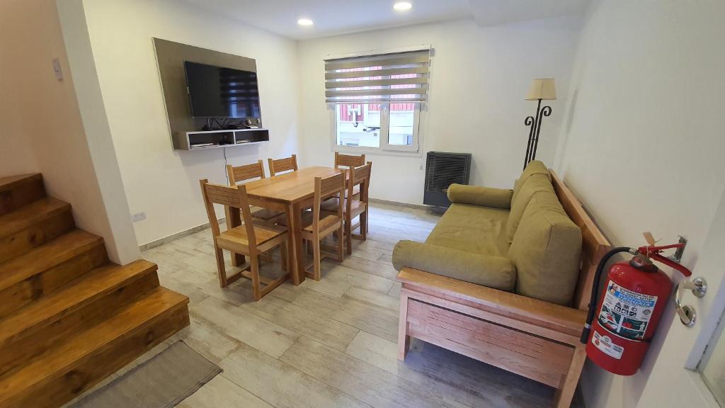 a living room with a couch and a table at Bahia's flat in Ushuaia