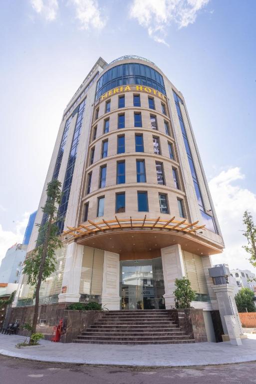 a tall building with stairs in front of it at MERIA Hotel Quy Nhơn in Quy Nhon