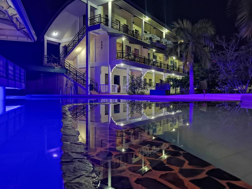 a house with a swimming pool at night at Nickles Park Resort in Panglao Island