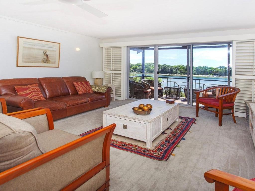 a living room with a couch and a table at Aroona at Minnamurra in Minnamurra