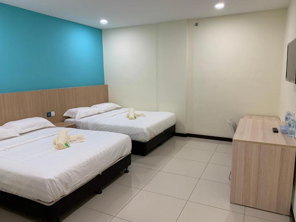 Postel nebo postele na pokoji v ubytování M Quality Hotel