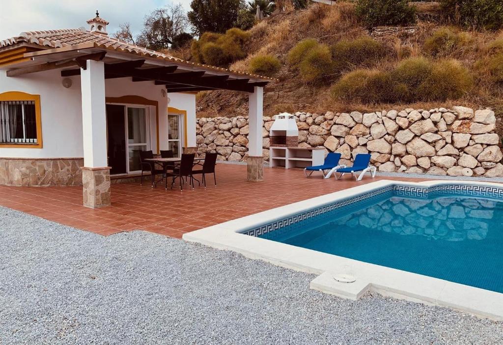 a villa with a swimming pool and a house at Casa Verdejo in Cómpeta