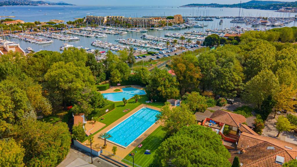 - une vue aérienne sur un port de plaisance avec une piscine et des bateaux dans l'établissement Marina Hôtel Club, à Cogolin