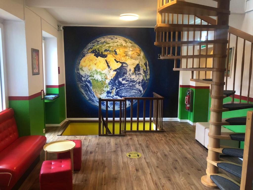 a room with a mural of the earth on the wall at Backpackers Düsseldorf - SELF CHECK-IN in Düsseldorf