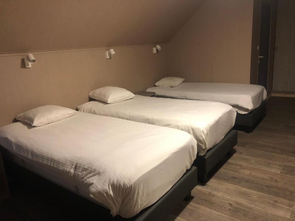 Postel nebo postele na pokoji v ubytování Hotel Oude Abdij