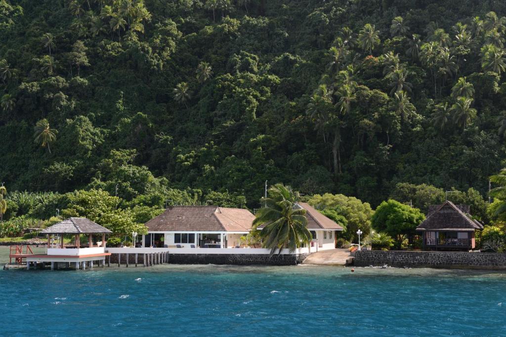 a house on a island in the water at Pension de famille HITI MOANA VILLA in Papara