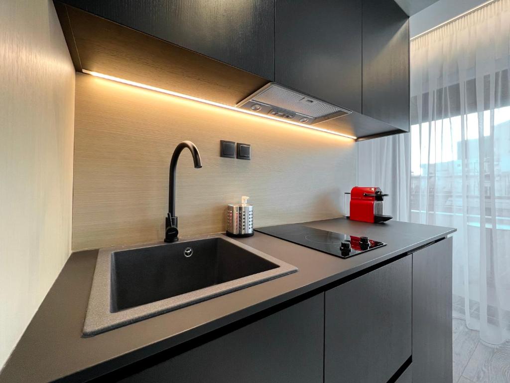 a kitchen with a sink and a counter top at ICON Urban Living in Thessaloniki