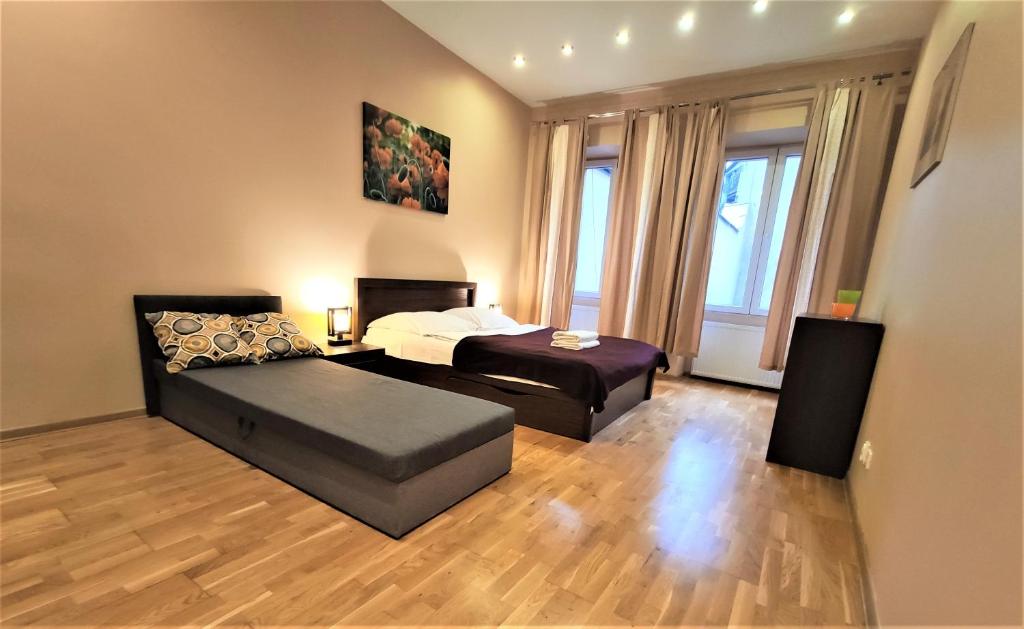 Posteľ alebo postele v izbe v ubytovaní Abak Krakow Apartment