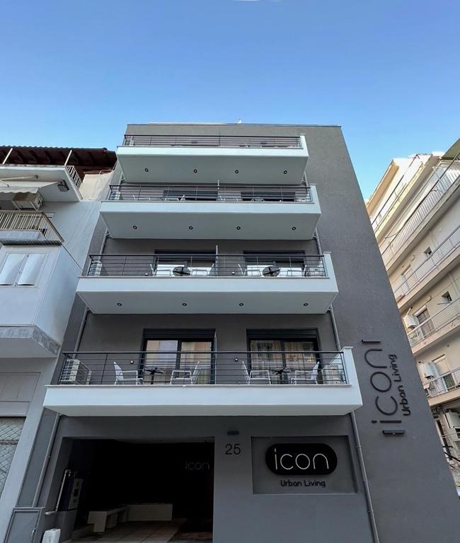 a tall white building with balconies on it at ICON Urban Living in Thessaloniki