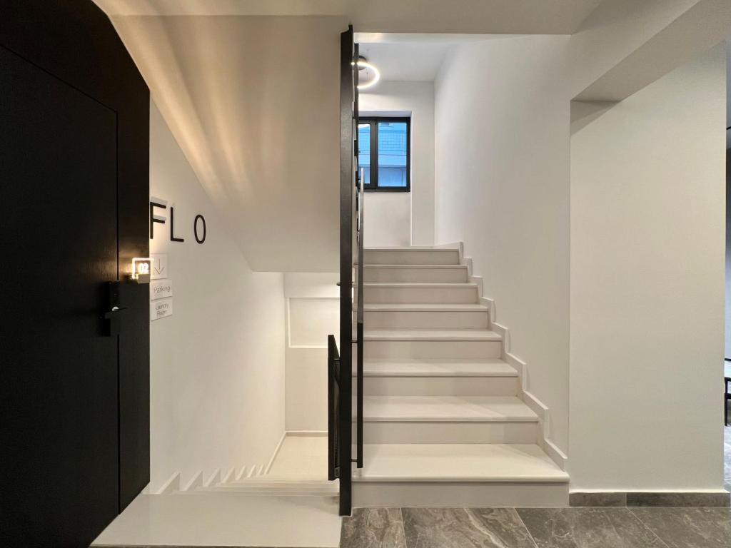 a staircase in a house with white walls at ICON Urban Living in Thessaloniki
