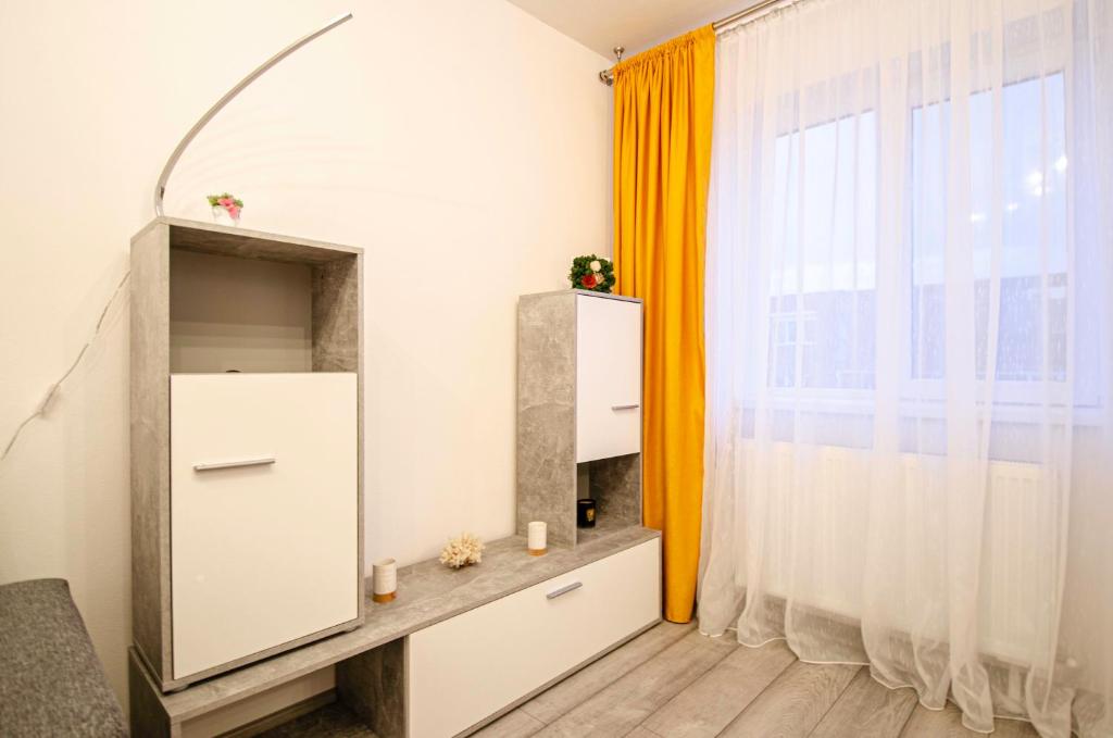 una camera con una grande finestra e un armadietto bianco di Miha modern and central apartament a Arad