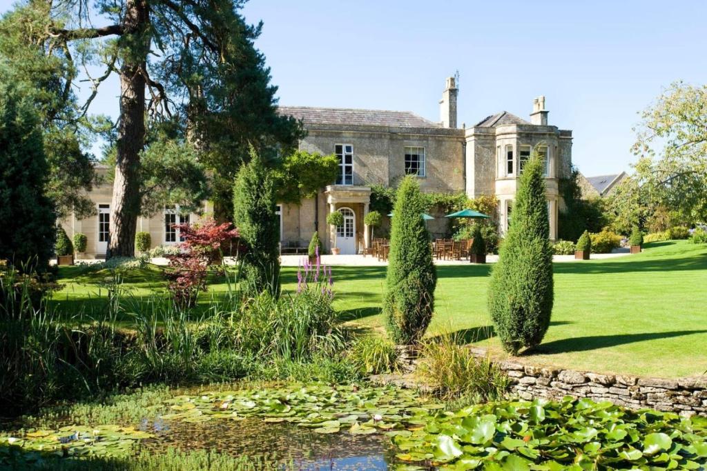 a house with a pond in front of it at Guyers House Hotel and Restaurant in Corsham