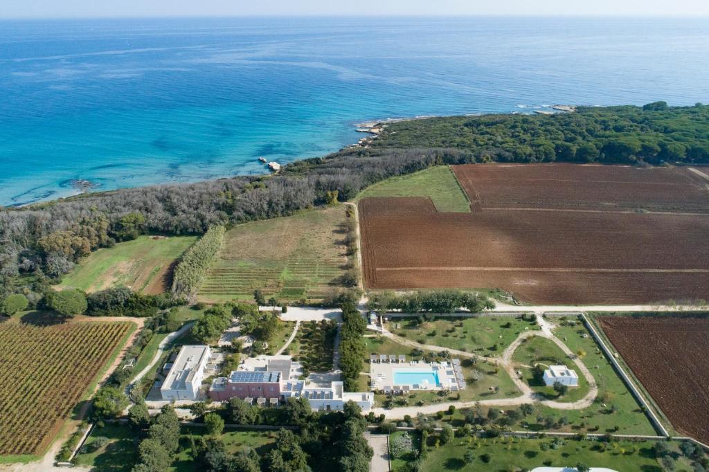 an aerial view of a farm and the ocean at Masseria Mongiò dell'Elefante in Otranto