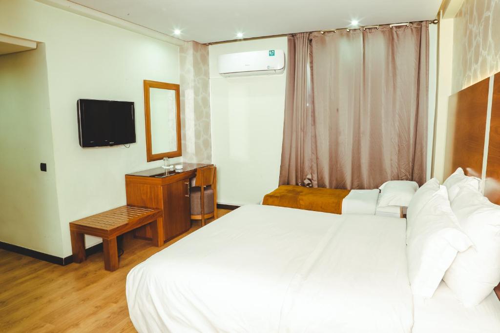 Postel nebo postele na pokoji v ubytování Hotel Perce Neige