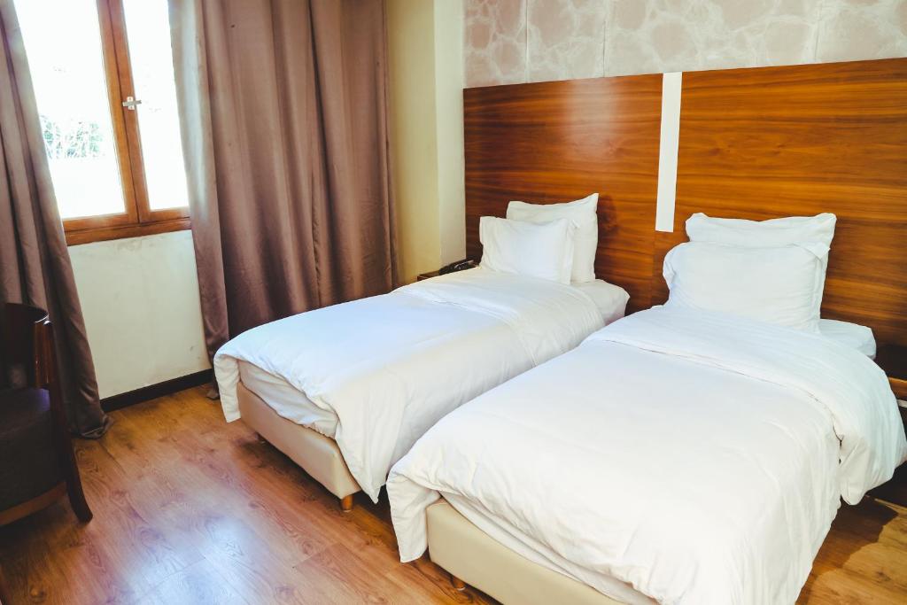 Postel nebo postele na pokoji v ubytování Hotel Perce Neige