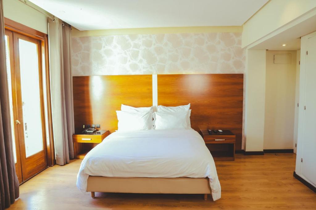 Postel nebo postele na pokoji v ubytování Hotel Perce Neige