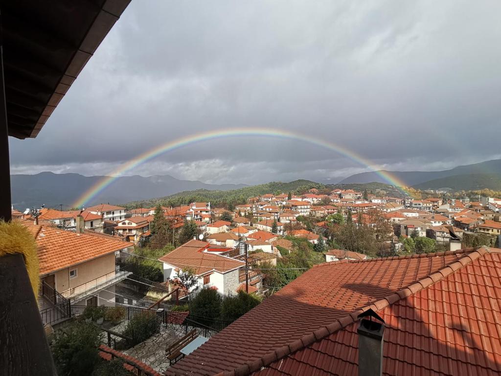 un arco iris sobre una ciudad con casas y tejados en Guesthouse Panorama en Vytina