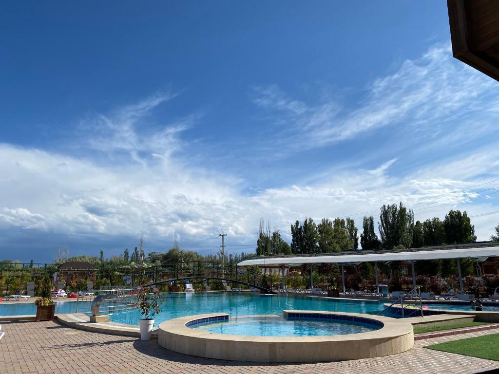 a large swimming pool in a resort at Raduga West Cottage 38-4 in Koshkolʼ