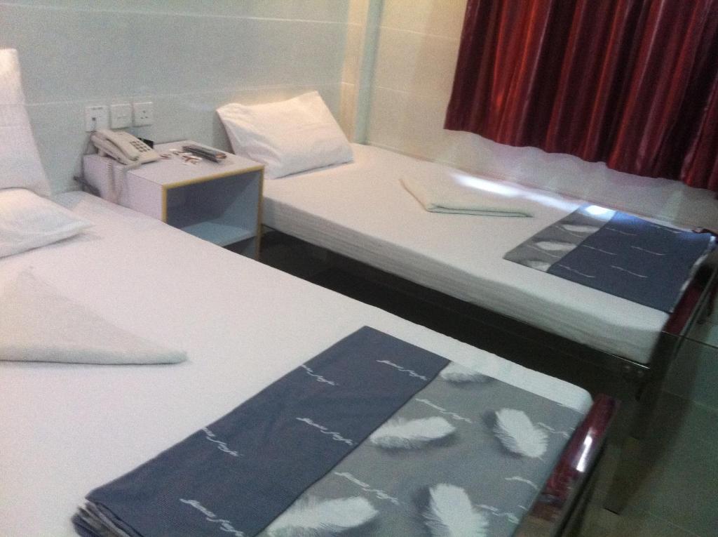 מיטה או מיטות בחדר ב-New Cosmos Hotel