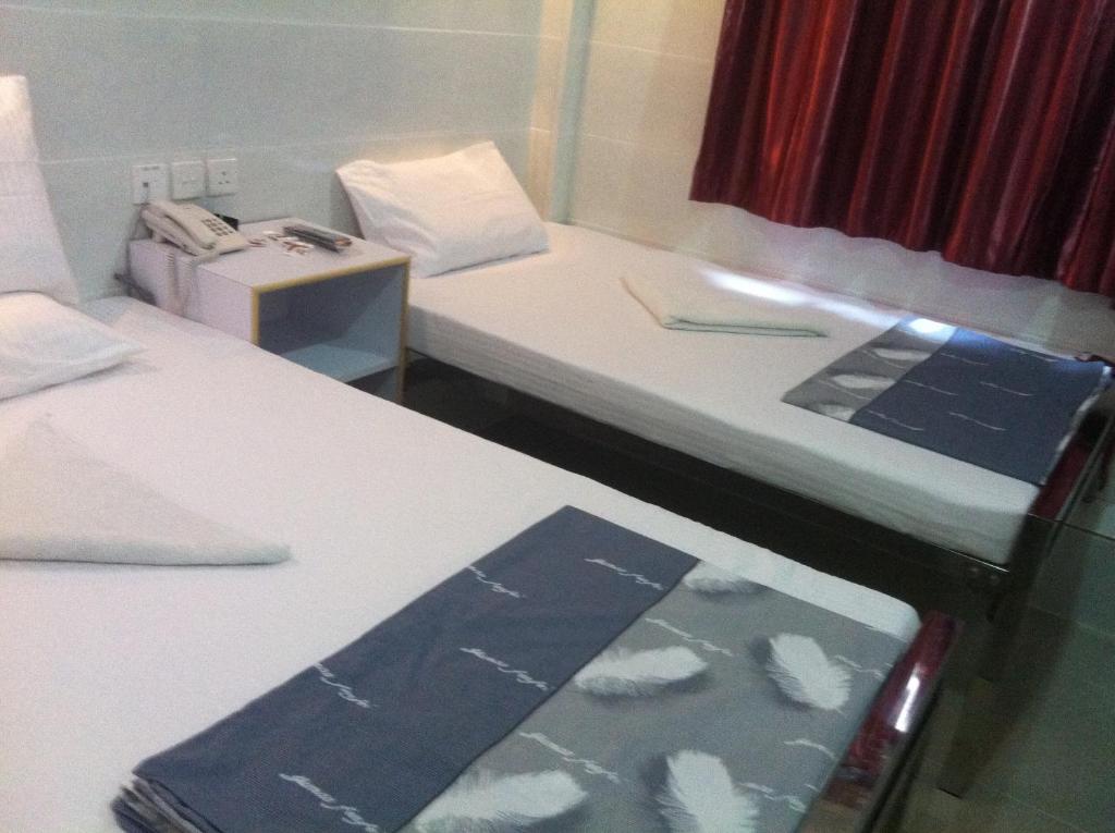 Postel nebo postele na pokoji v ubytování New Cosmos Hotel