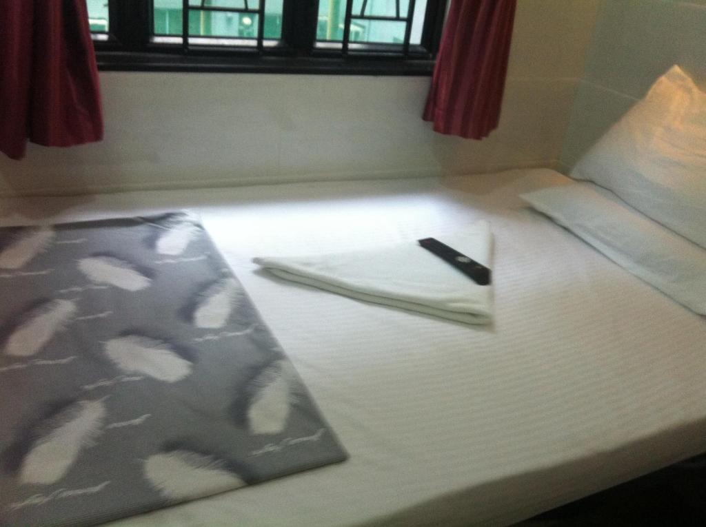 Postel nebo postele na pokoji v ubytování New Cosmos Hotel