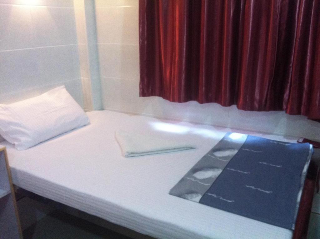 Postel nebo postele na pokoji v ubytování New Cosmos Hotel