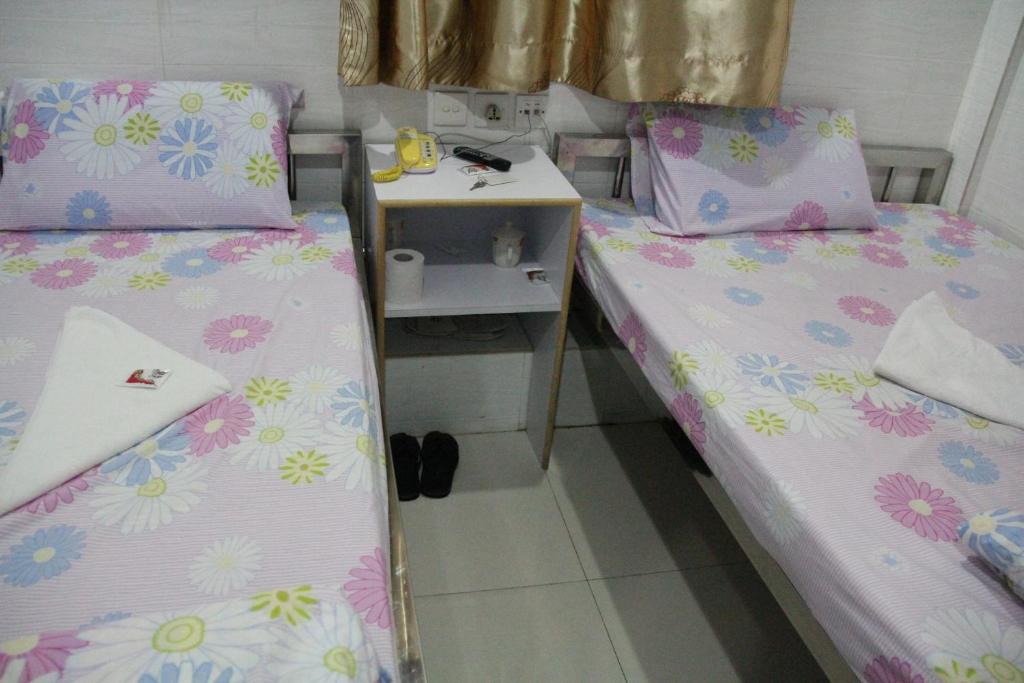 Postel nebo postele na pokoji v ubytování New Cosmos Hotel