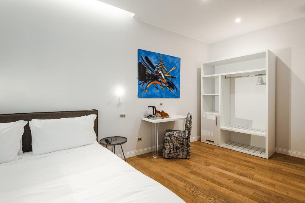 a bedroom with a bed and a desk in it at Nikis Collection Trastevere in Rome
