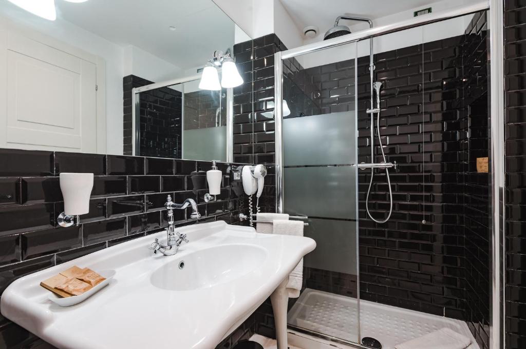 a bathroom with a sink and a shower at Nikis Collection Trastevere in Rome