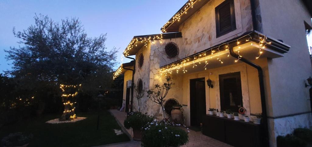 a building with christmas lights on the side of it at Casa Vacanza Villa Romano in Nicolosi