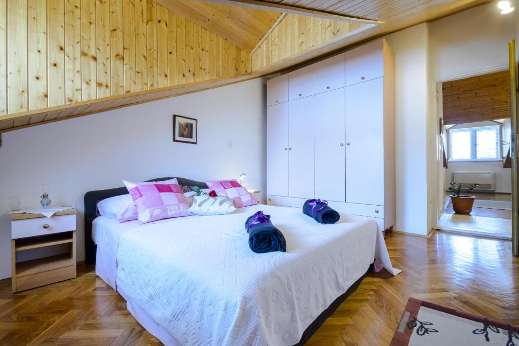 a bedroom with a bed with two bags on it at Apartment Matic in Dubrovnik