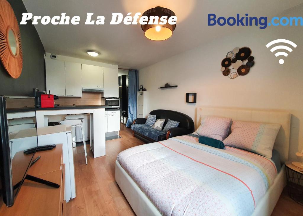 1 dormitorio con cama, escritorio y cocina en Studio design proche Défense-Paris en Rueil-Malmaison