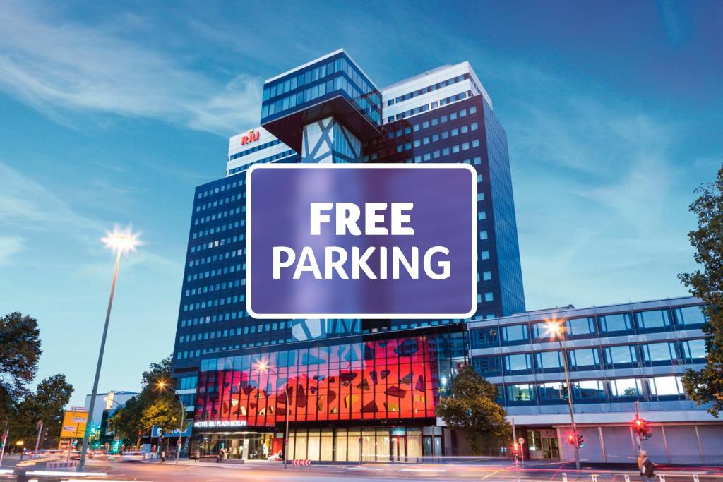 a free parking sign in front of a building at Riu Plaza Berlin in Berlin