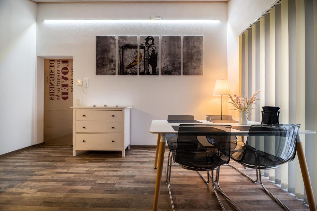 a dining room with a table and two chairs at Gemütliche Ferienwohnung mit Panoramablick in Muttensweiler