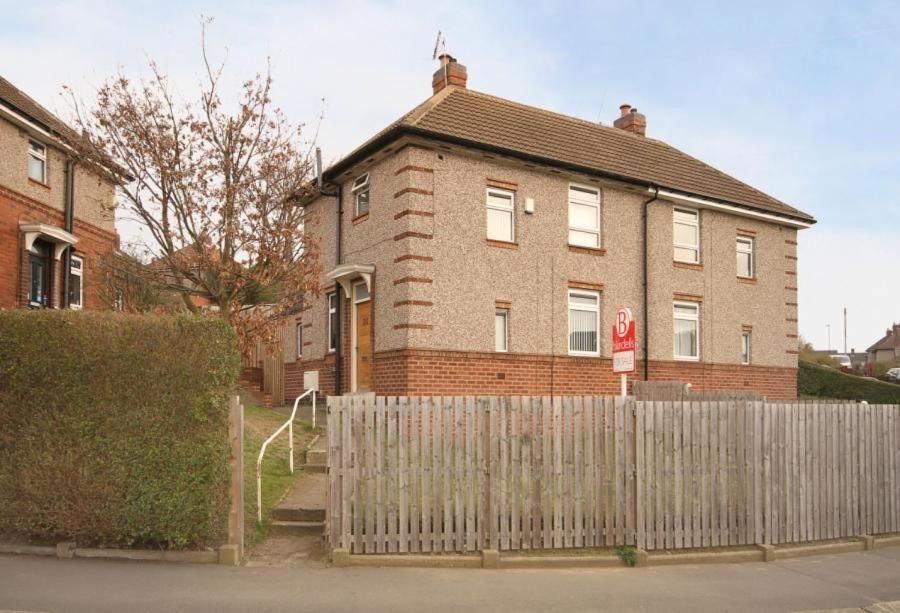 a brick house with a fence in front of it at 24 Dryden Road - Beautiful 2 bed in Longley