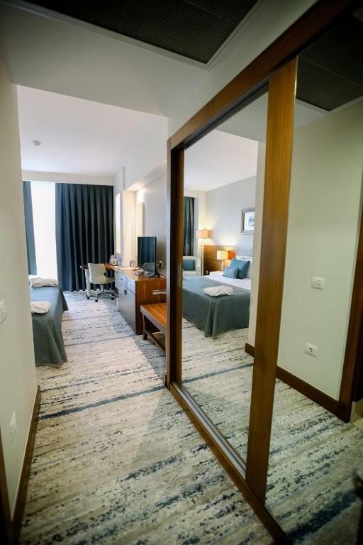 A bed or beds in a room at Baia Bursa Hotel