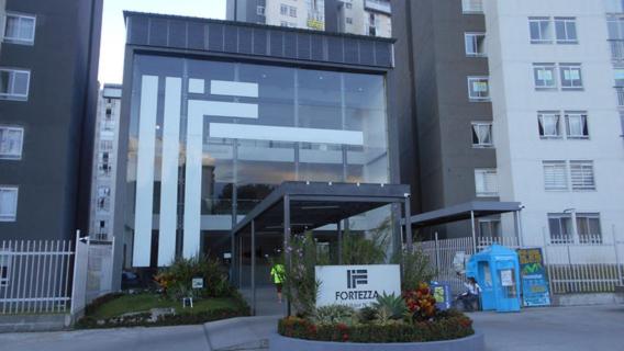 a large building with a sign in front of it at apartamento fortezza ByB in Ibagué