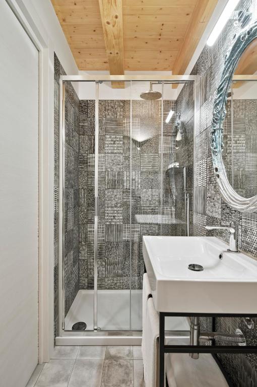 a bathroom with a shower and a sink at Crocevia - Locanda carsica contemporanea in Trieste