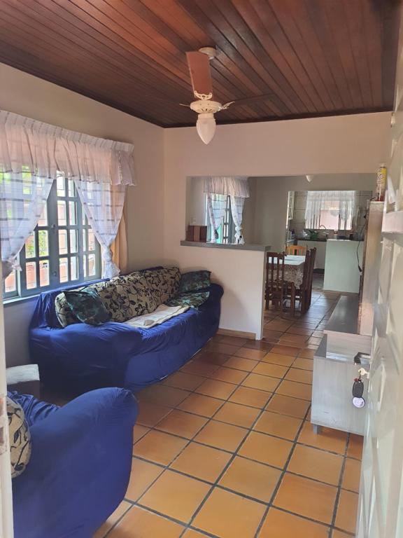 a living room with two blue couches in a room at Leal house in Matinhos