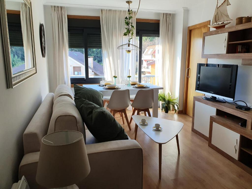 a living room with a couch and a table at Acogedor apartamento en Boiro in Boiro