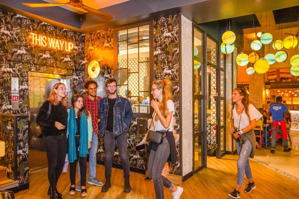 a group of people standing in front of a store at Villa Saint Exupery Beach Hostel in Nice