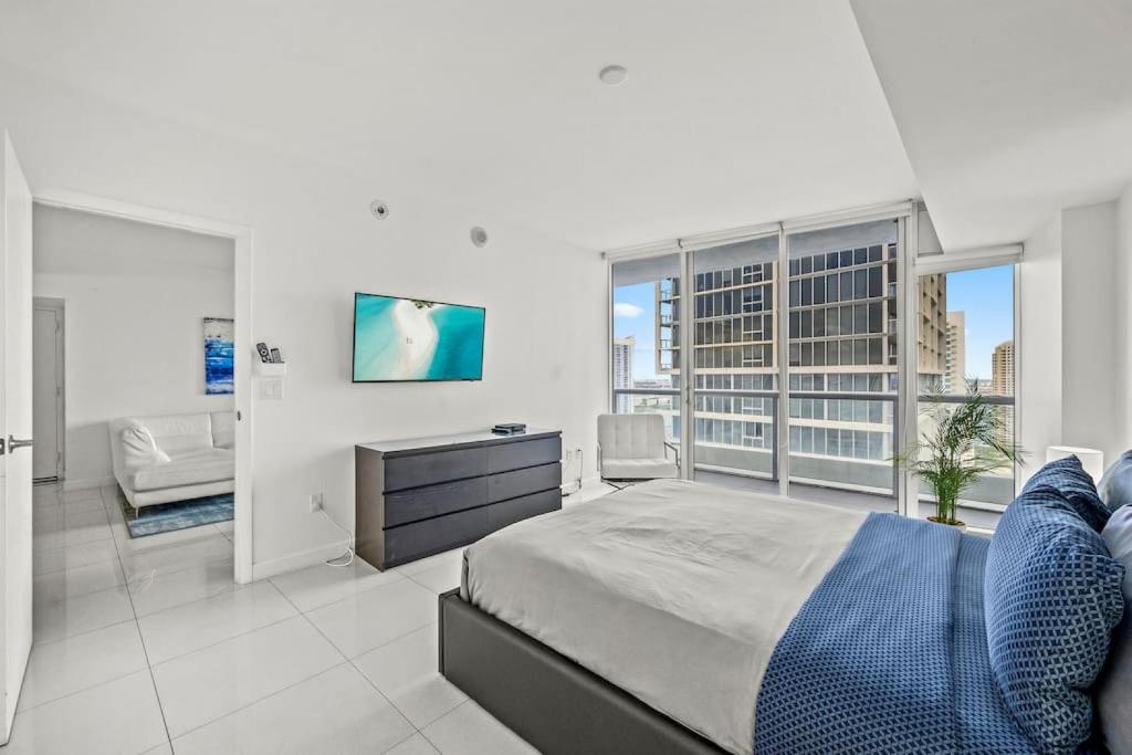 a bedroom with a king sized bed and a television at Inredible View -Luxury Unit at the W Brickell in Miami